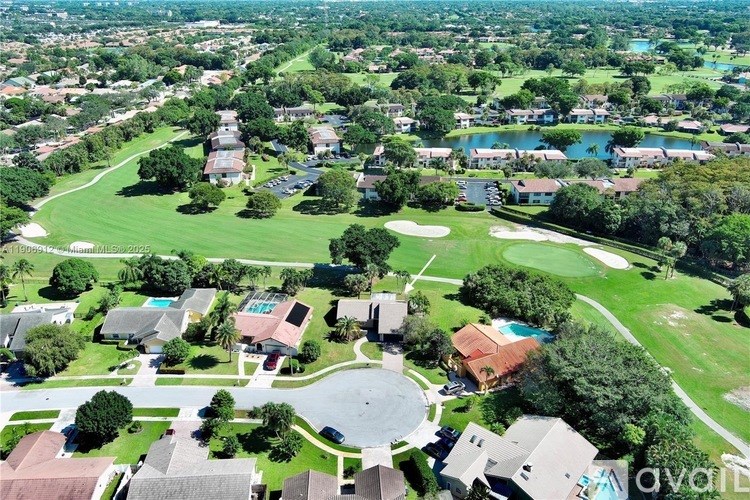 A bird's eye view of a residential area with a golf course.