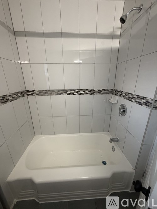 A white bathtub with a black and white checkered border.