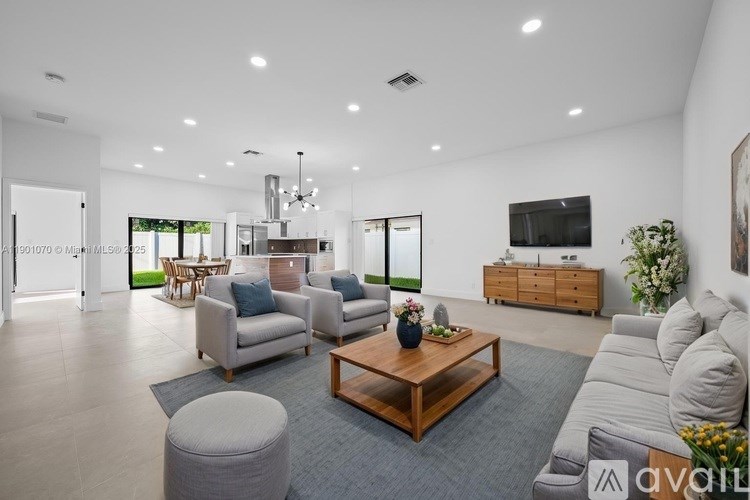 A modern living room with a wooden coffee table and grey sofa.