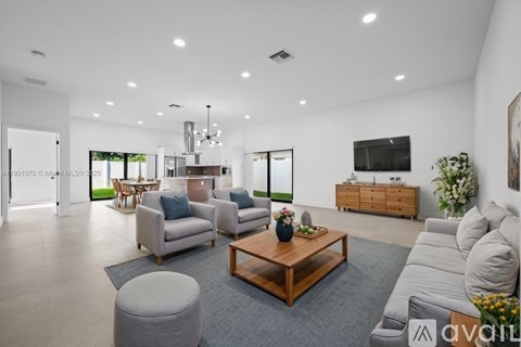 A modern living room with a wooden coffee table and grey sofa.
