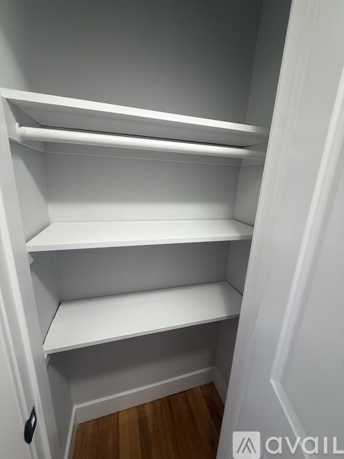 Empty white shelves in a corner.
