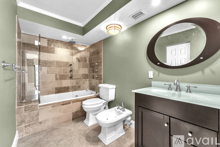 A bathroom with a toilet, sink, and tub.