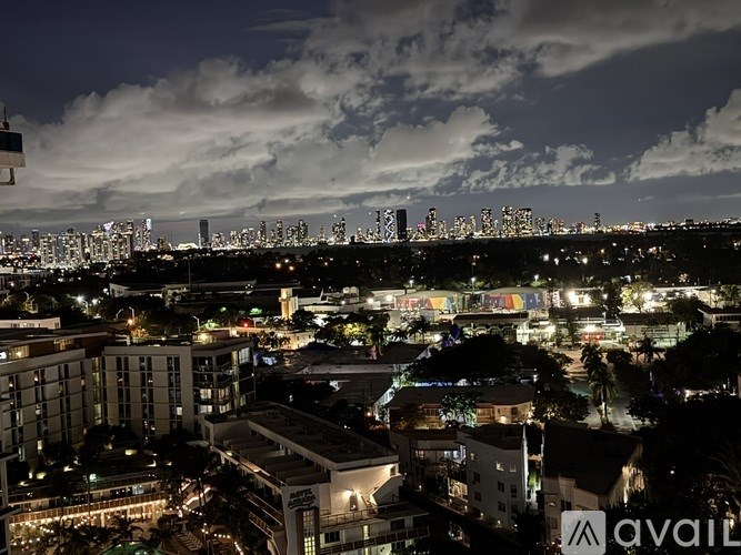 A cityscape at night with buildings and lights.
