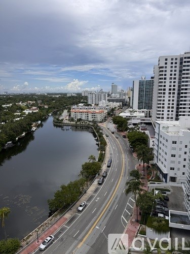 A city street with a river running alongside it.