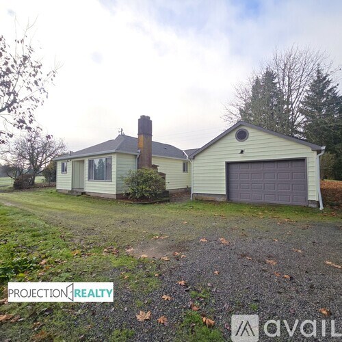 A house with a grey garage door is for sale.