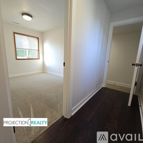 A room with a window and a door is available for rent.