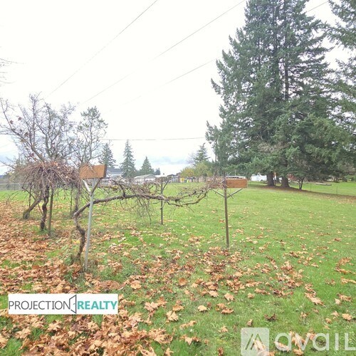 A field with a sign that says PROJECTION REALTY.