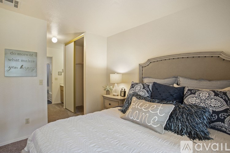 A bedroom with a large bed and a sign on the wall.