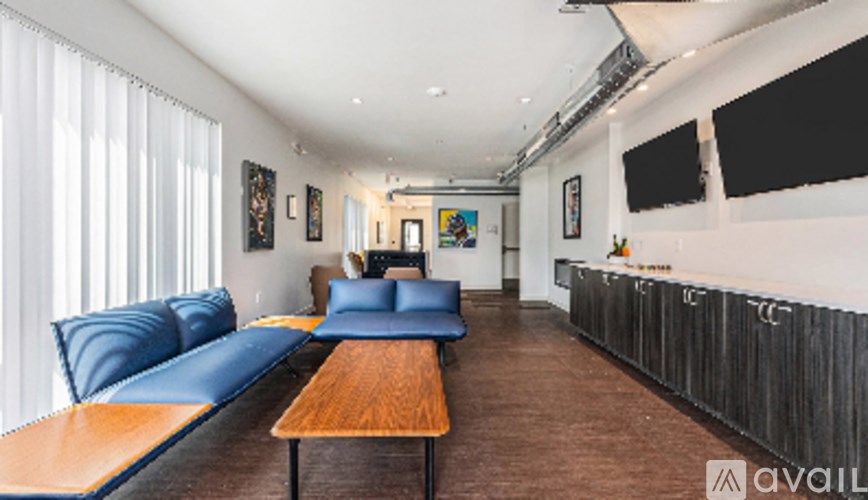 A living room with a long couch and a wooden table.