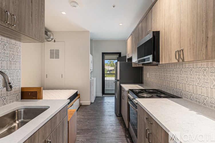 A kitchen with wooden cabinets and a black stove top oven.