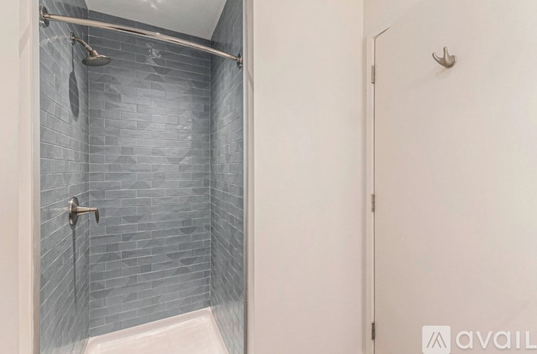 A bathroom with a shower and a door.