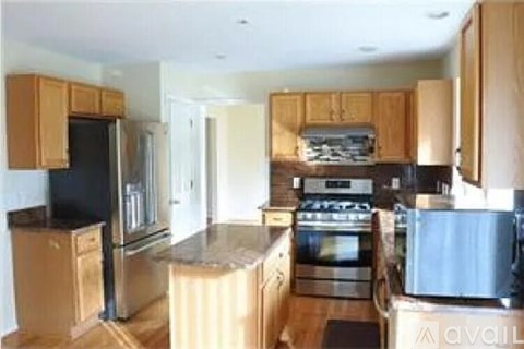 A kitchen with wooden cabinets and stainless steel appliances.