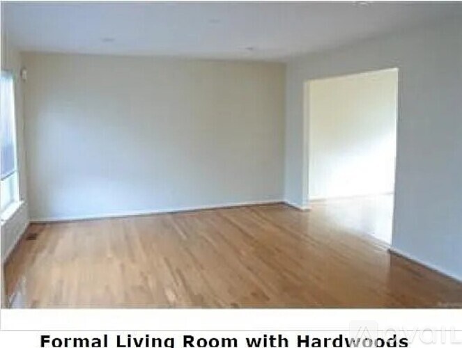 A formal living room with hardwood floors.