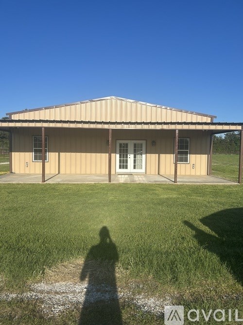 A house with a shadow of a person in front of it.