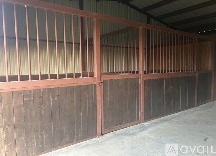 A large room with wooden walls and a metal railing.