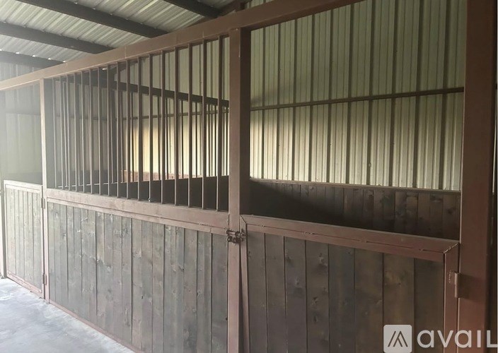 A wooden fence with metal bars on top.