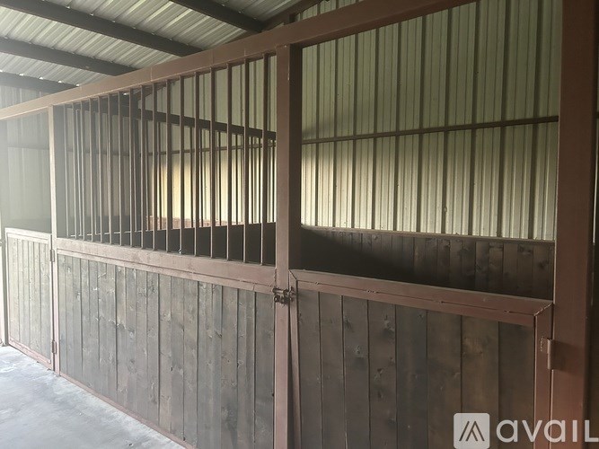 A wooden fence with metal bars on top.
