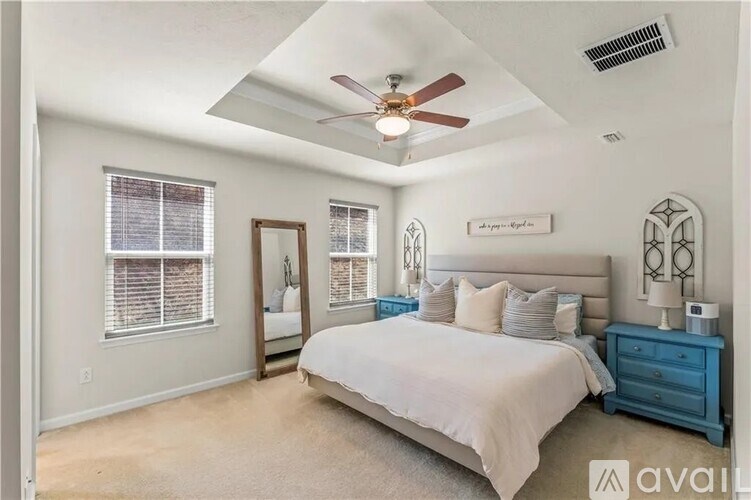 A bedroom with a bed, dresser, and mirror.