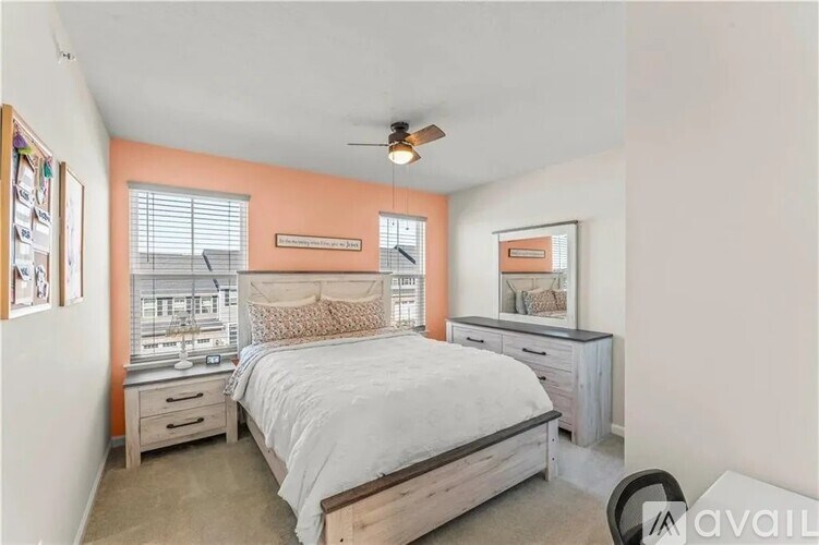 A bedroom with a bed, dresser, and mirror.