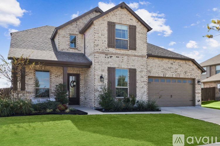 A house with a stone facade and a large front yard.