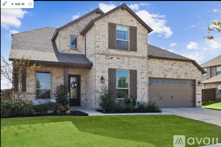 A large house with a stone facade and a garage.