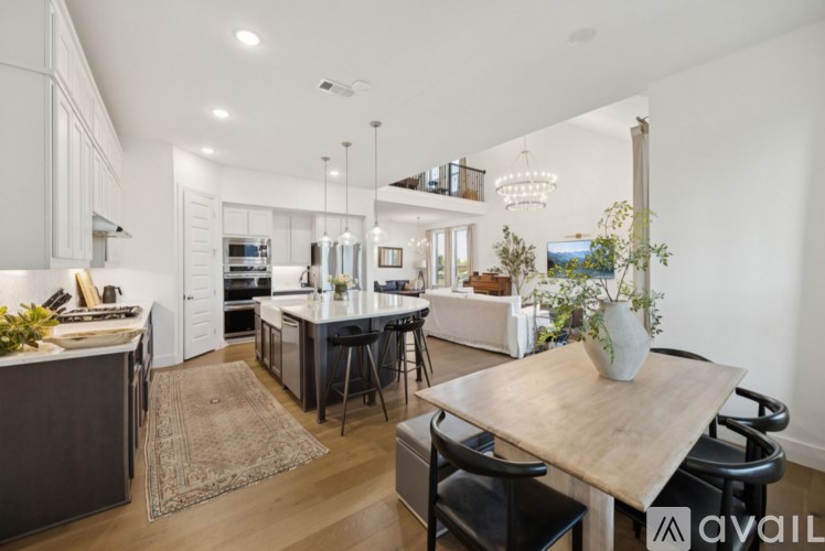 A modern kitchen with a dining area and a living room.