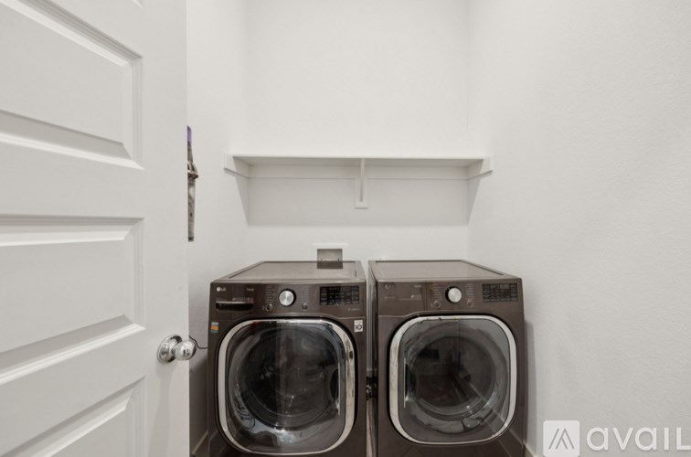 Two front load washing machines in a laundry room.