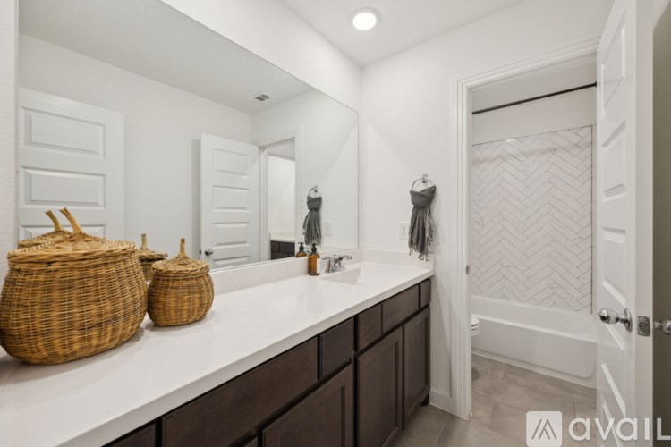 A bathroom with a white countertop and a white door.