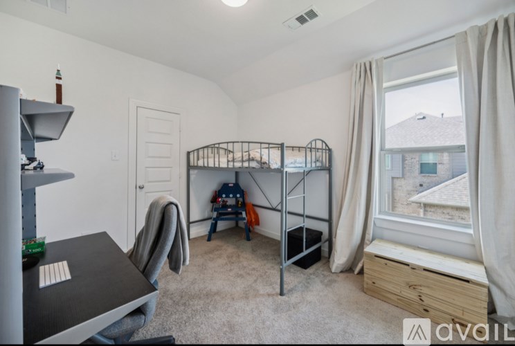 A room with a bunk bed and a desk.