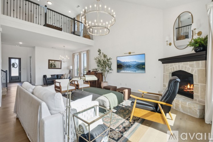 A living room with a fireplace and a TV mounted on the wall.