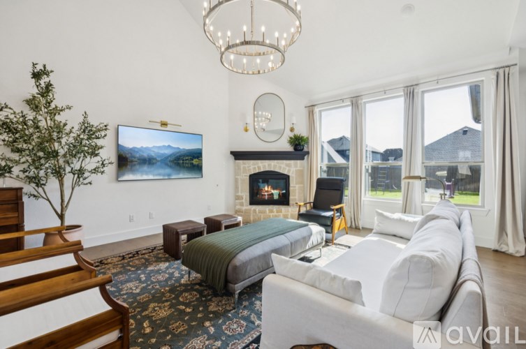 A living room with a fireplace and a large painting on the wall.