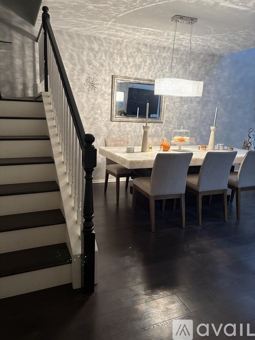 A dining room with a table set for four.