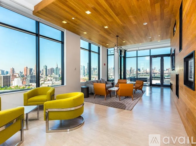 A living room with yellow chairs and a view of the city.