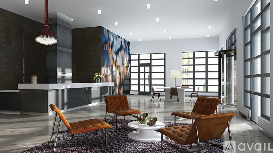 A modern living room with a large rug and a long table.