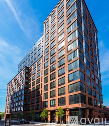 A tall red brick building with many windows.