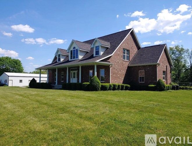 A house with a large lawn in front of it.