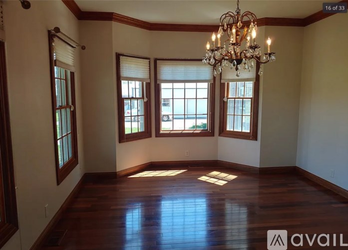 A room with wooden floors and a chandelier.