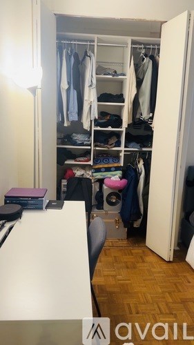 A small closet with clothes and shoes.
