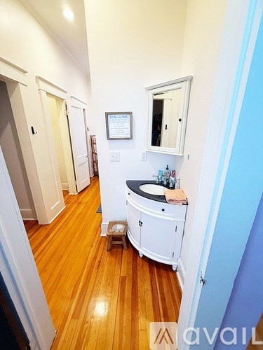 A bathroom with a sink and mirror on the wall.