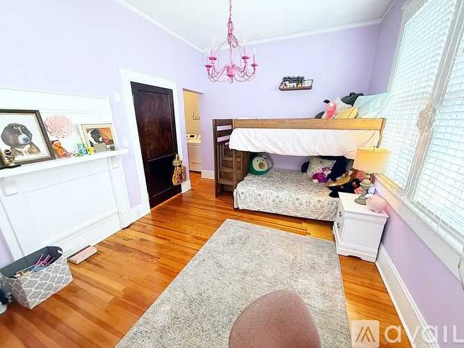 A room with a bunk bed and a chandelier.