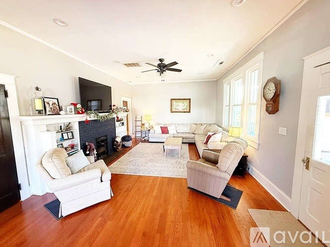 A living room with a fireplace and a television.