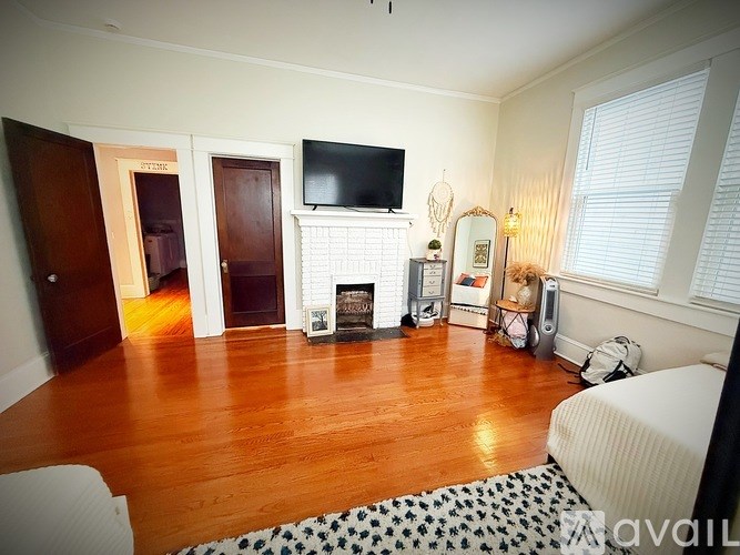 A living room with a fireplace and a television.