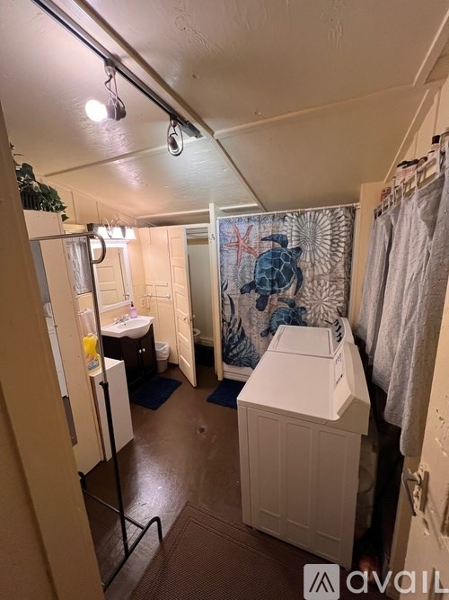 A bathroom with a white sink and a white toilet.