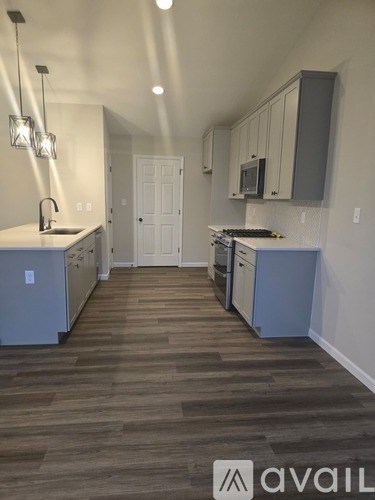 A kitchen with a white door and a counter.