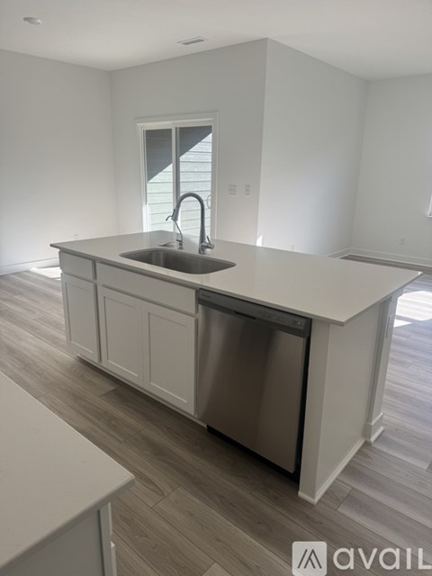 A kitchen with a sink and a window.