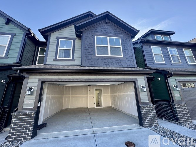 A row of houses with garages in front.