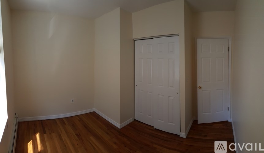 A room with a white door and a white closet door.