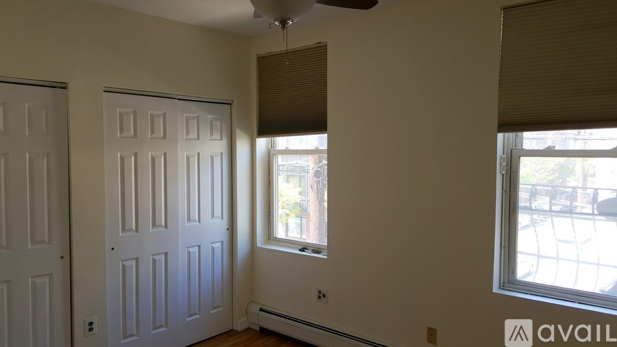 A room with a window and a ceiling fan.