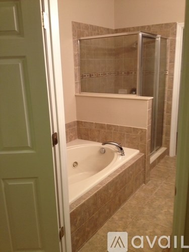 A bathroom with a tub and a walk in shower.