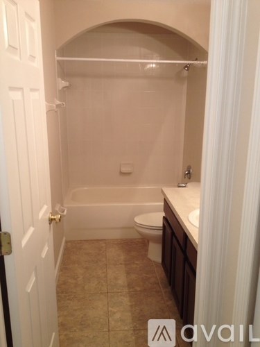 A bathroom with a toilet, sink, and bathtub.